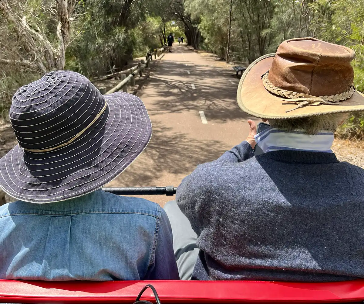 Two passengers on the trishaw cycling through Baigup Wetlands with Community Bank Bayswater support