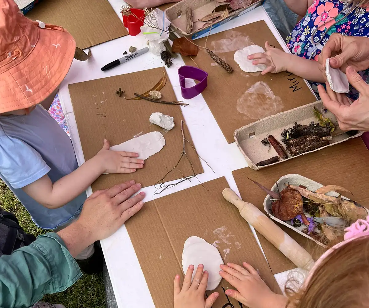 The small hands of children doing craft and learning about nature with Community Bank Bayswater support