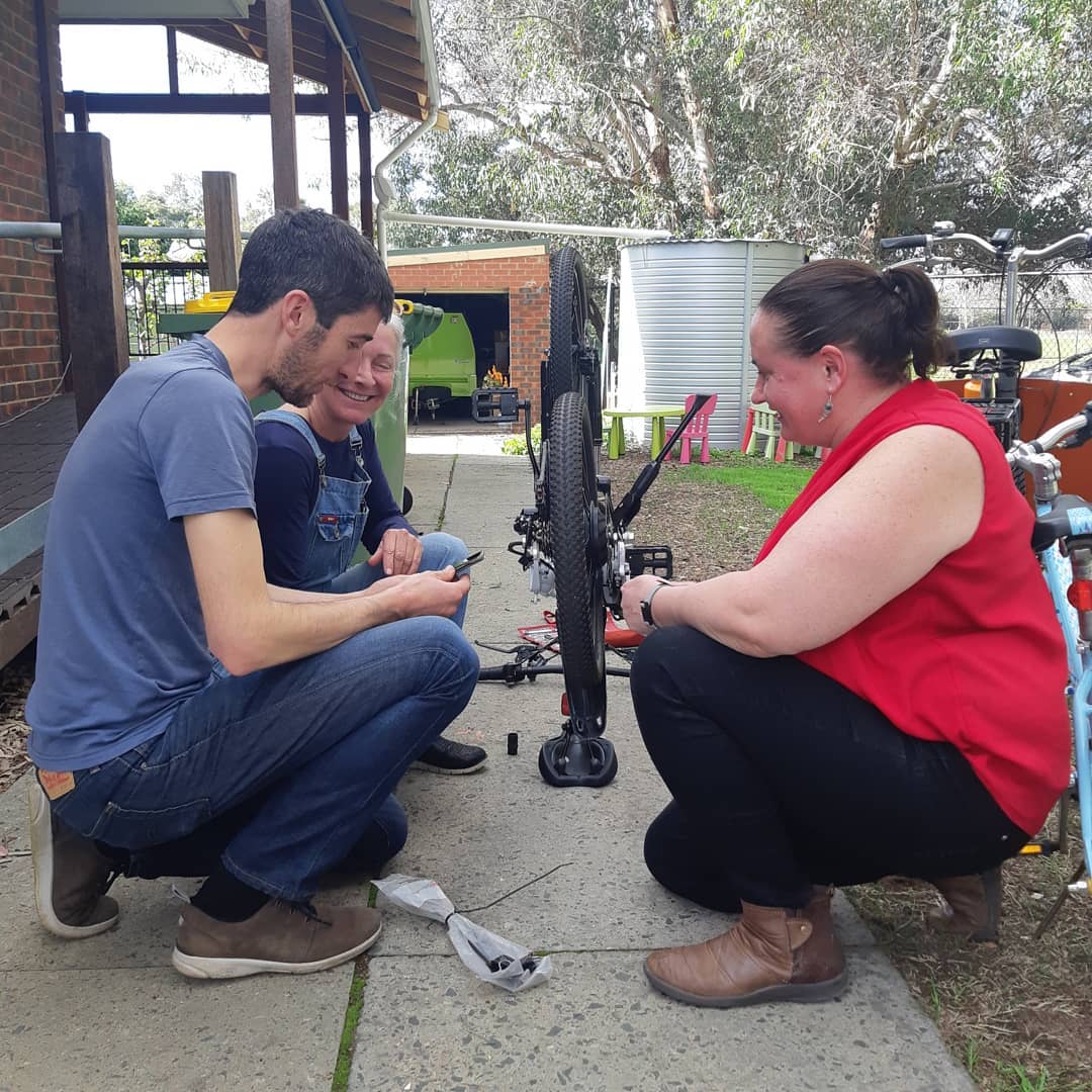 A volunteer repairing a bicycle